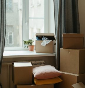 brown cardboard box on white bed